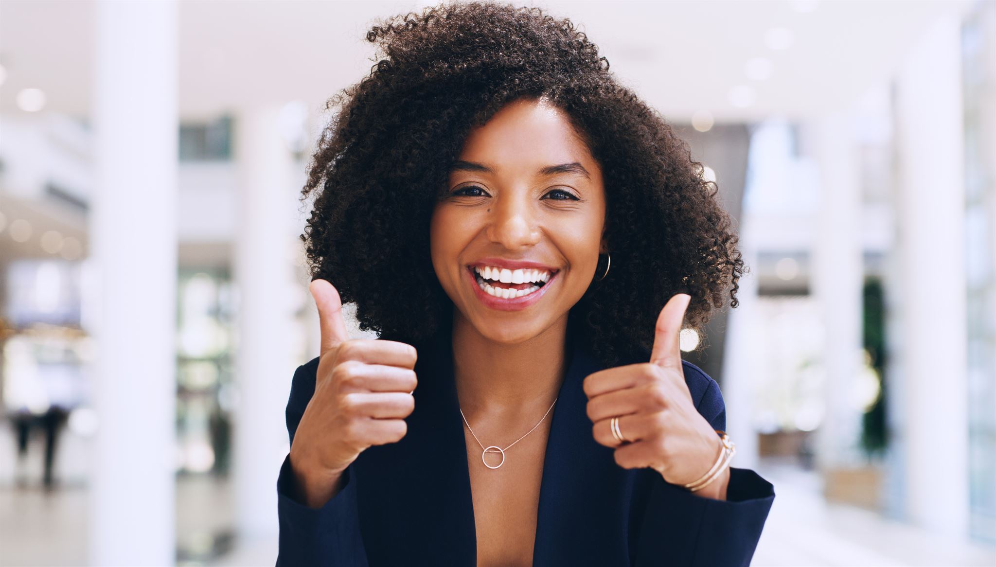 Woman-smiling-and-giving-two-thumbs-up